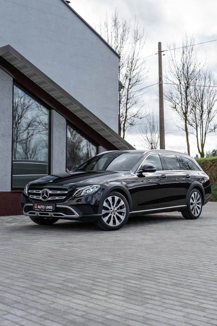 A sleek black Mercedes Benz parked on a paved street, showcasing luxury and elegance.