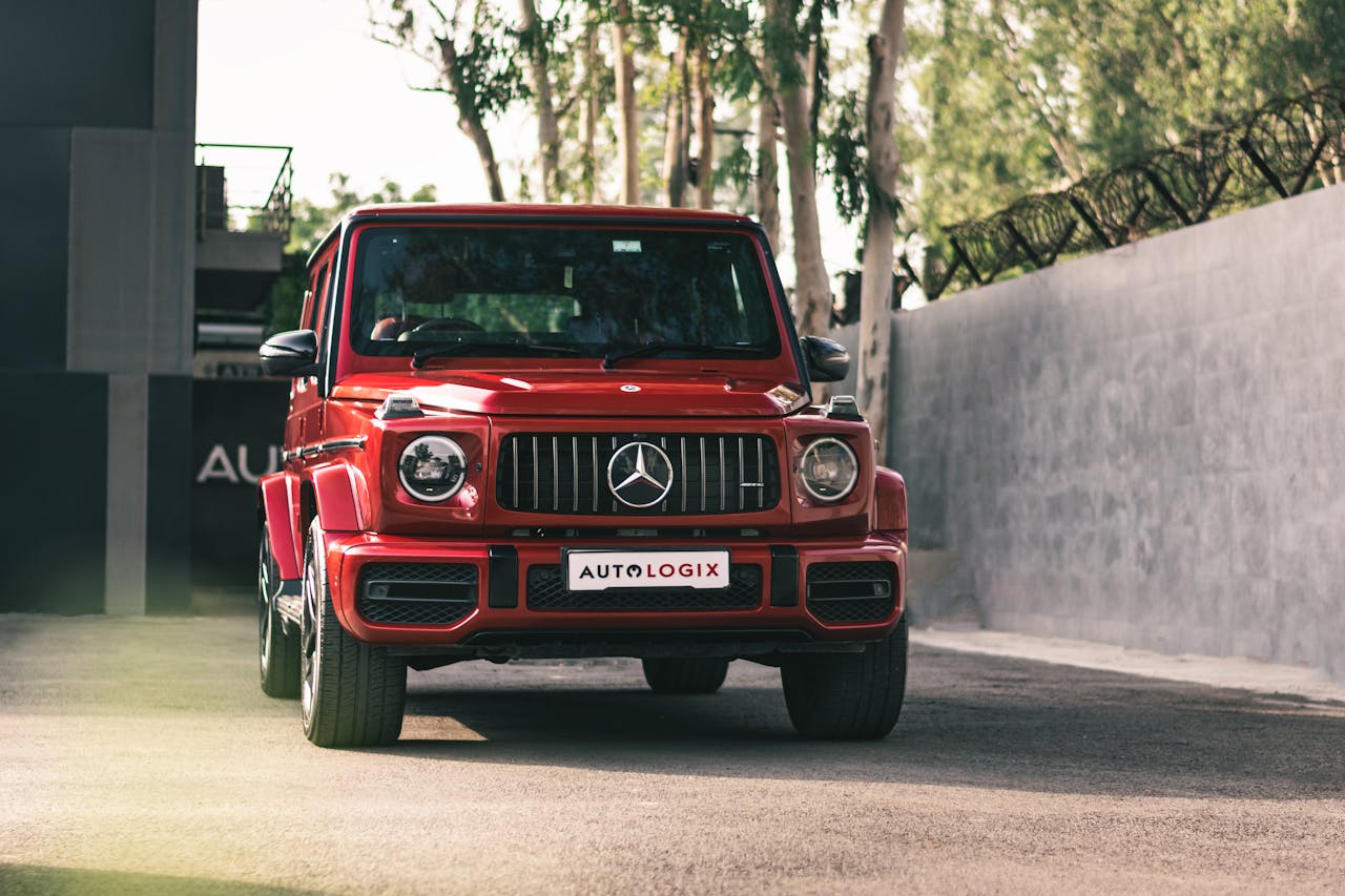 A striking red Mercedes SUV parked at an urban crossroad, showcasing modern automotive design.