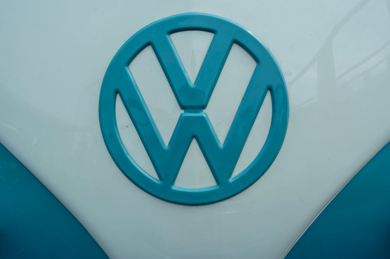 Close-up of the Volkswagen logo on a vintage car hood, showcasing iconic design.